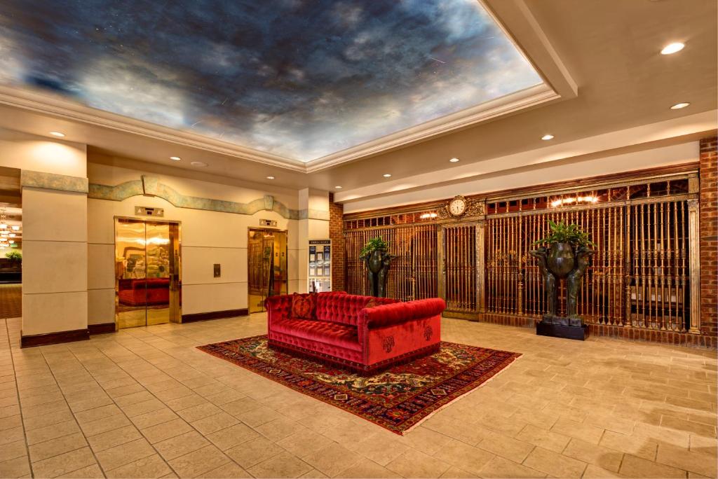 a lobby with a red couch in a room at Carnegie Hotel & Spa in Johnson City