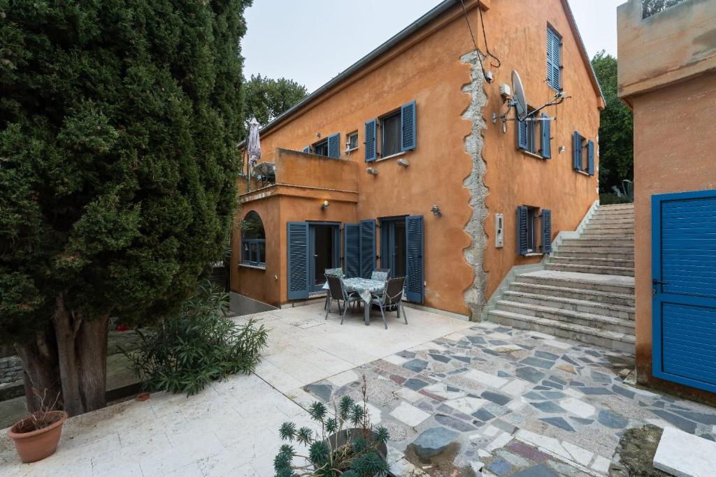 an outdoor patio with a table and chairs next to a building at Apartments Rialto in Veli Lošinj