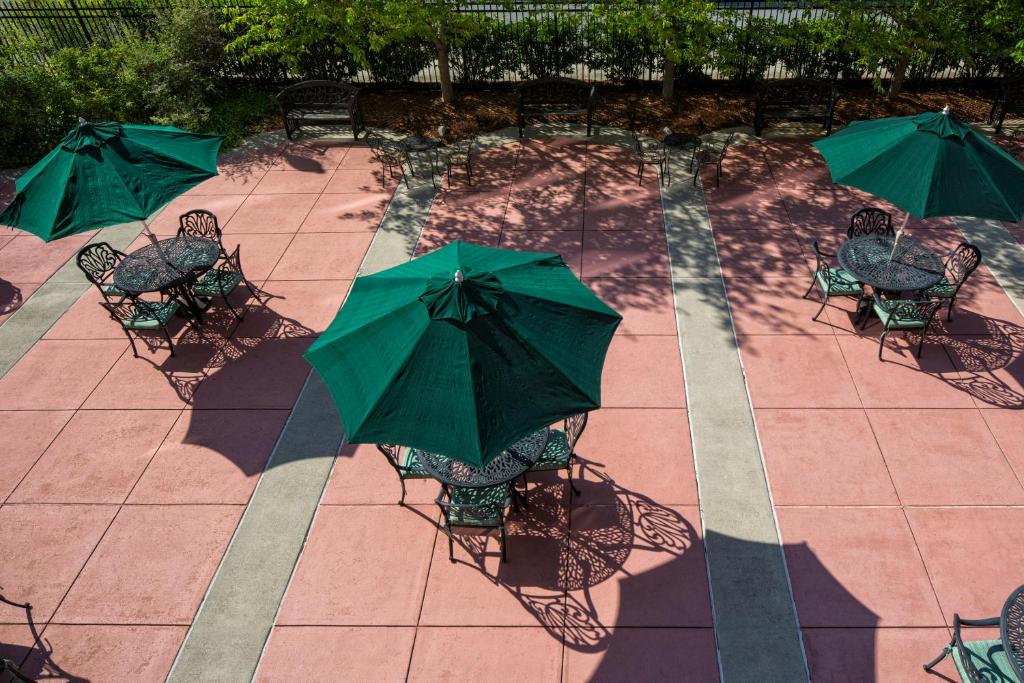 a group of chairs with green umbrellas on a patio at Carnegie Hotel & Spa in Johnson City