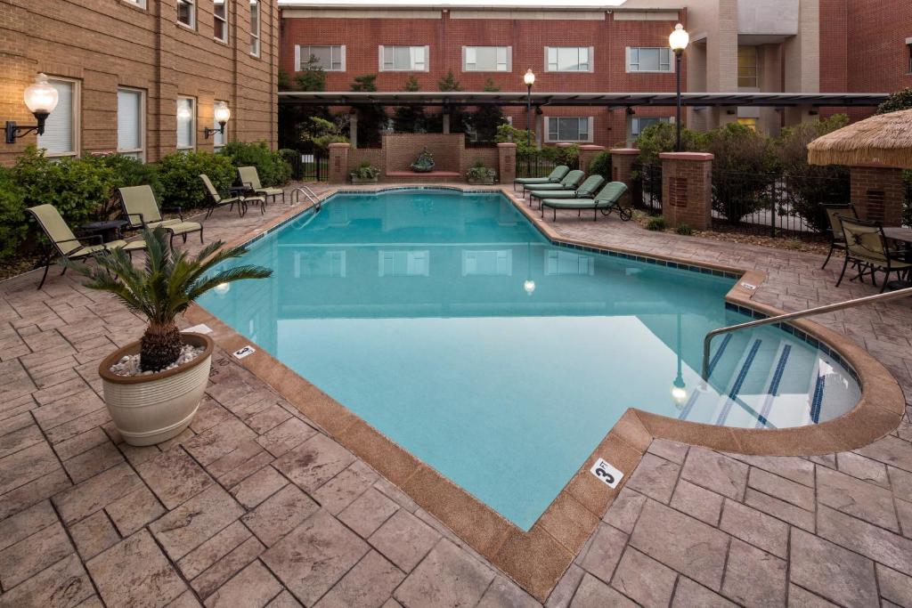 a large swimming pool in a courtyard with a hotel at Carnegie Hotel & Spa in Johnson City