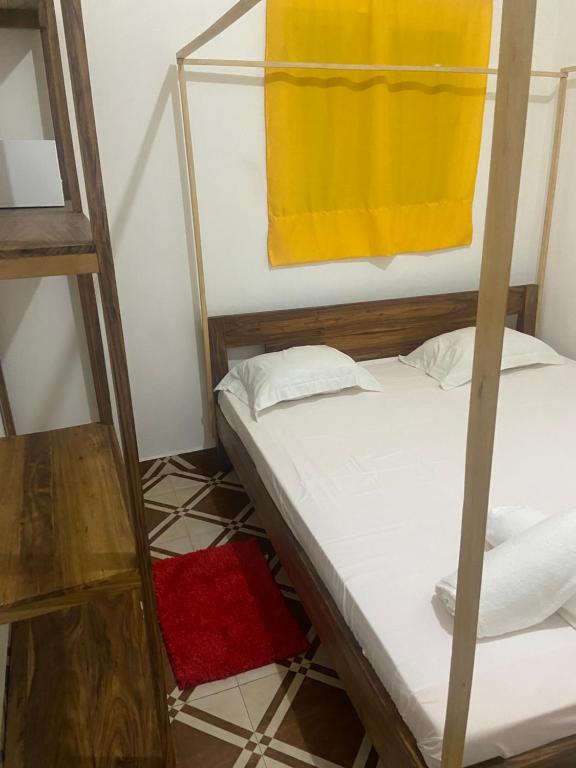 a room with two bunk beds and a yellow towel at Bee Rooms Nosy be in Ambatoloaka