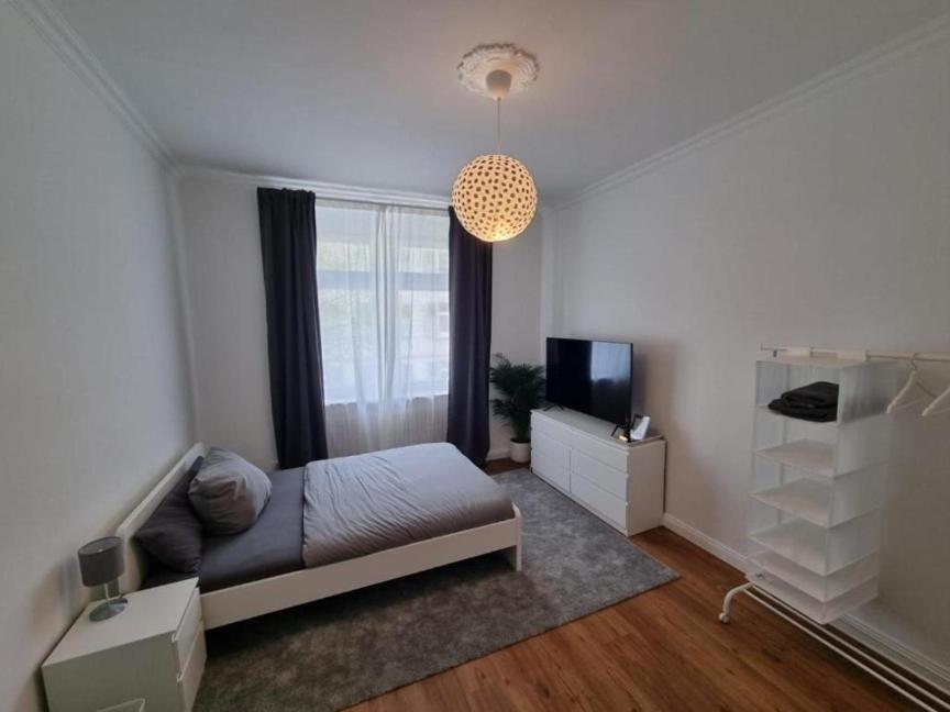 a bedroom with a bed and a television in it at Süße Marie 3 in Karlsruhe