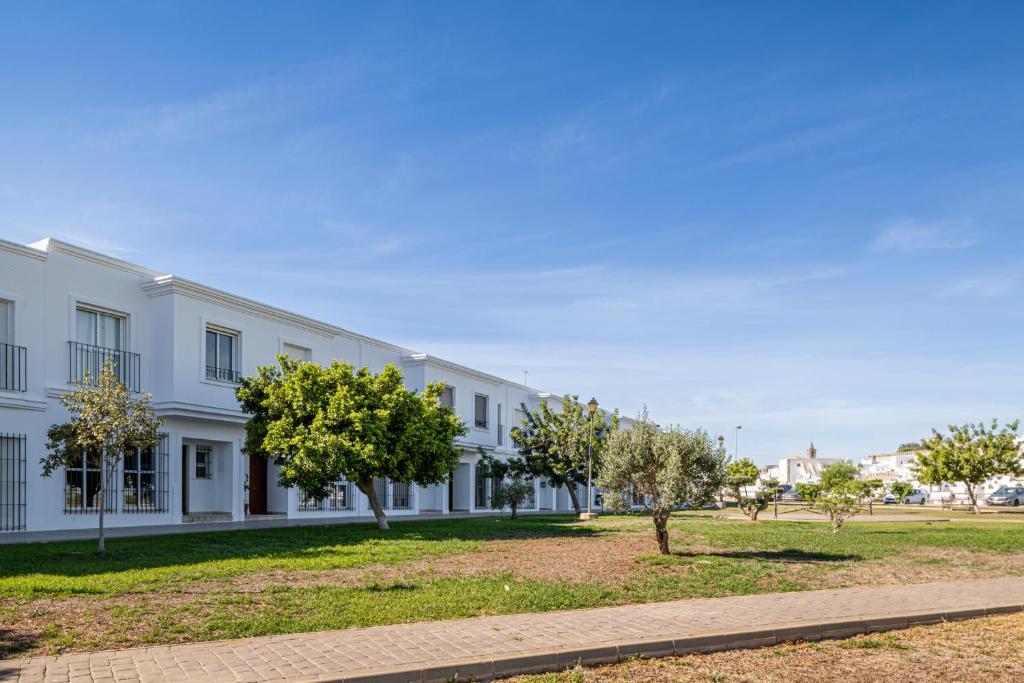 a white building with trees in front of it at Rincón del Sur in Vejer de la Frontera