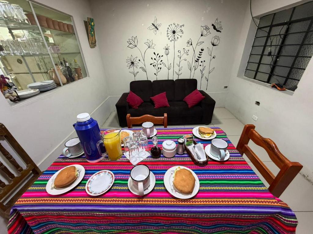 a table with plates of food on top of it at Hospedaje Quillabamba in Santa Teresa