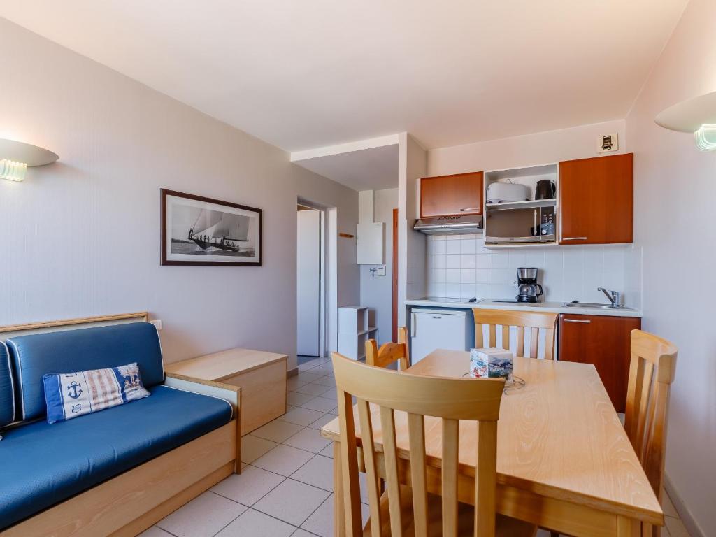 a living room and kitchen with a table and a couch at L Ocean N40 2P5 in La Tranche-sur-Mer