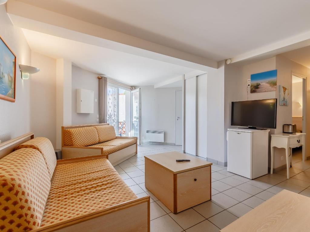 a living room with a couch and a tv at L Ocean N08 3P5 in La Tranche-sur-Mer