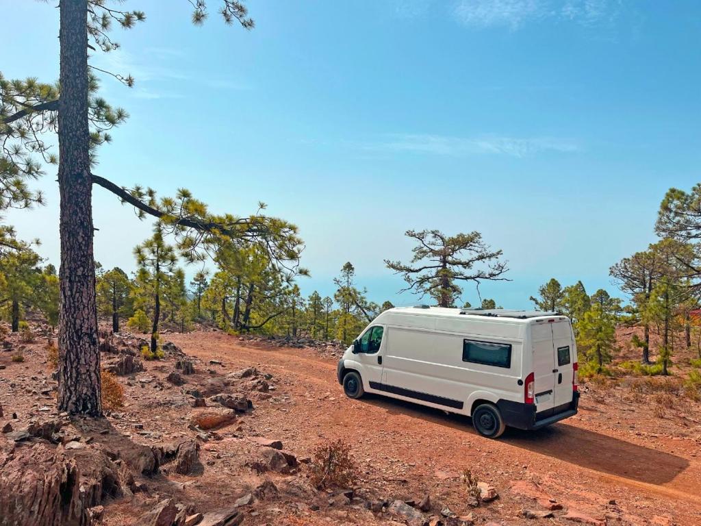 a white camper van parked on a dirt road at Tenerife Stylish Camper Van with Bathroom in Arona