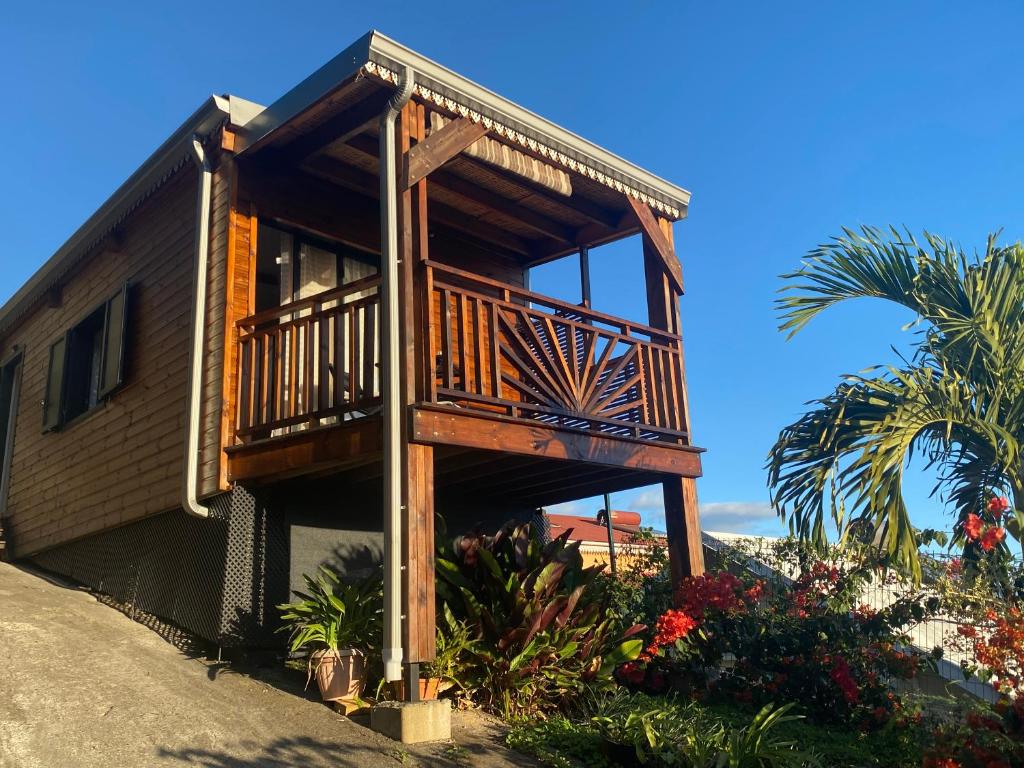 a house with a deck on the side of it at Chez Sylvie et Philippe in LʼEntre-Deux