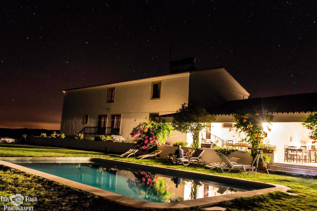 a house with a swimming pool at night at Herdade D. Pedro in Terena