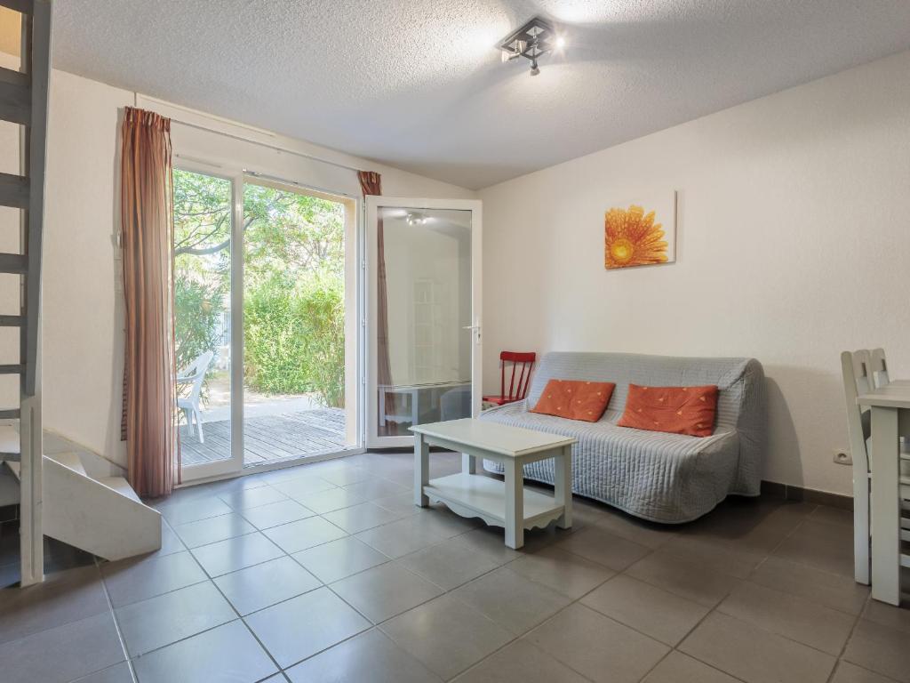 a living room with a bed and a table at D du Ventoux D N55 3P6 in Aubignan