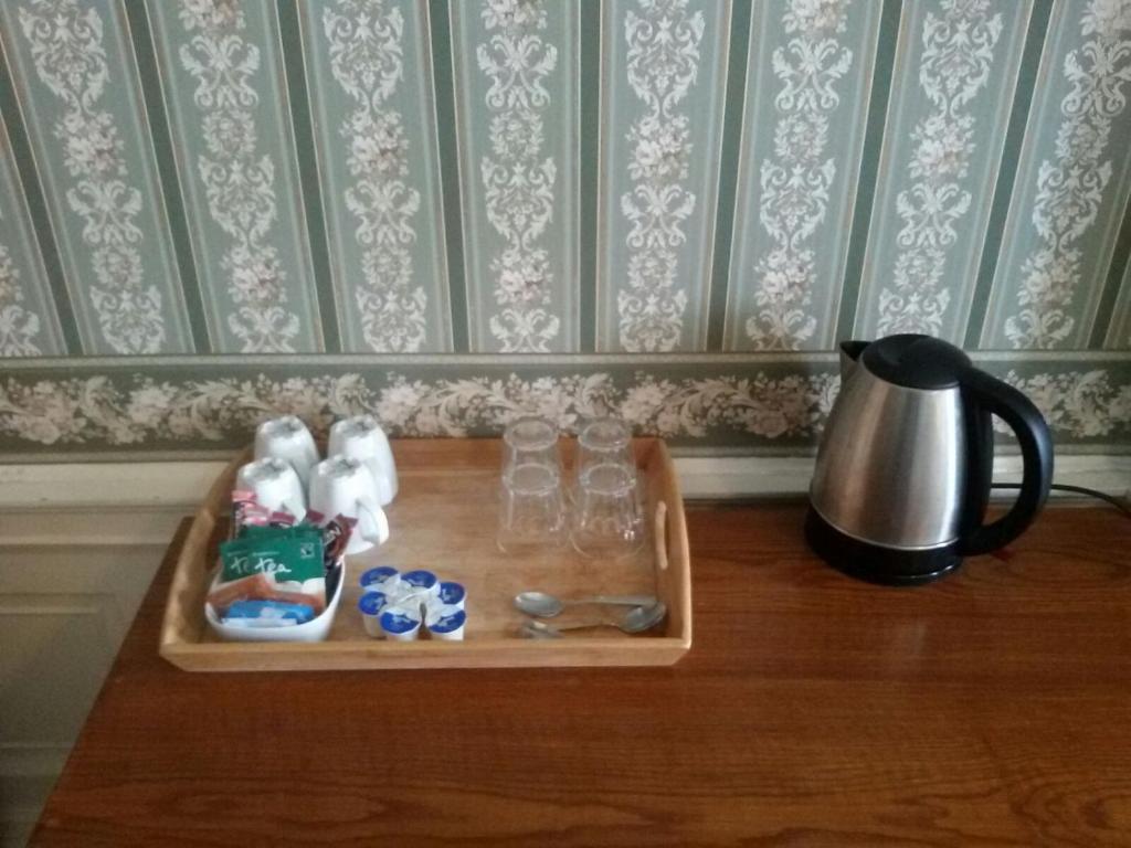 bandeja con vasos y tetera sobre una mesa en Adelphi Hotel, en Edimburgo