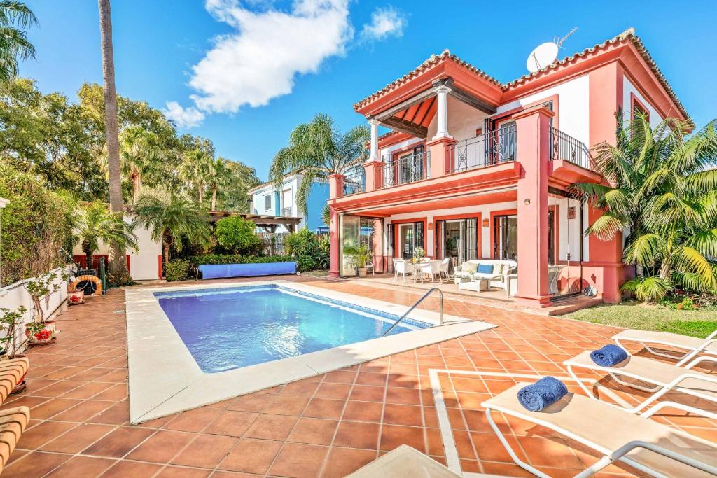 an exterior view of a house with a swimming pool at Villa Oceana in Manilva