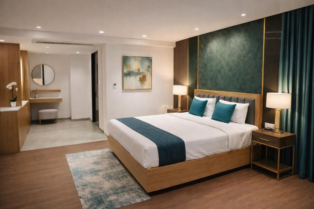 a hotel room with a large bed and a bathroom at Kriya Grandeur Hotel in Secunderabad