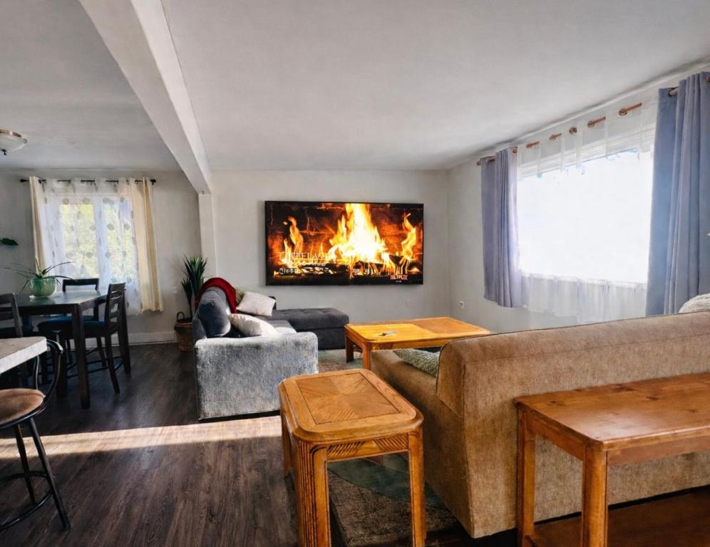a living room with a couch and a fireplace at Mountain Joy Getaway in Valemount