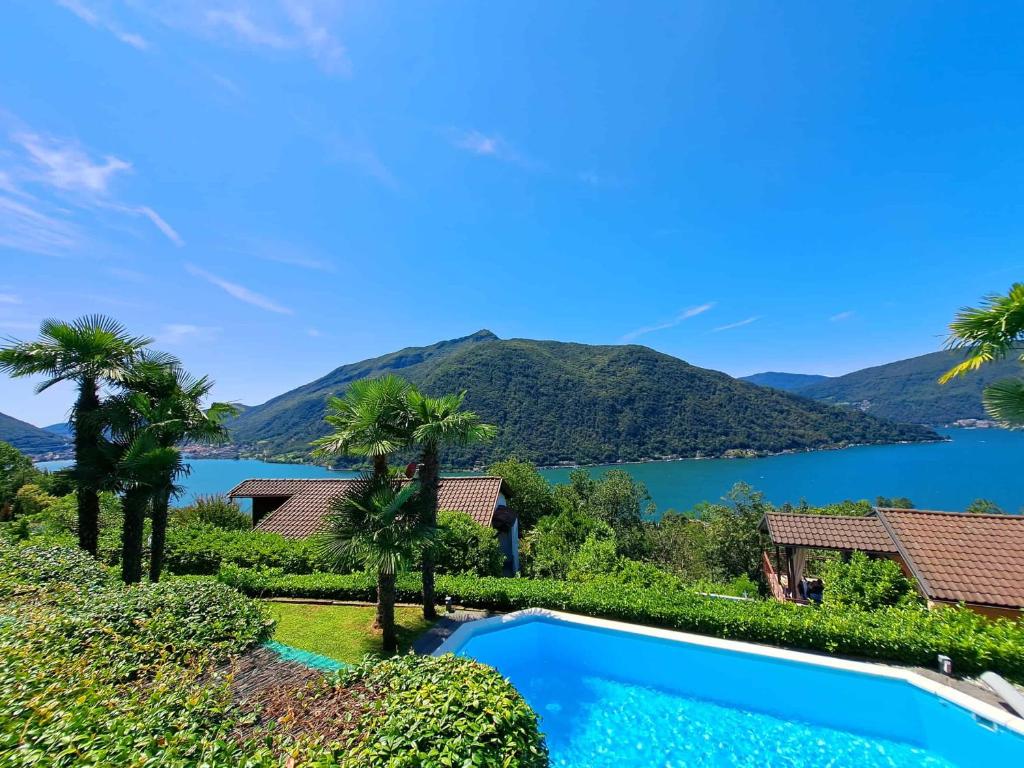 a swimming pool with a view of a lake at Casa Bellavista Rovio in Rovio