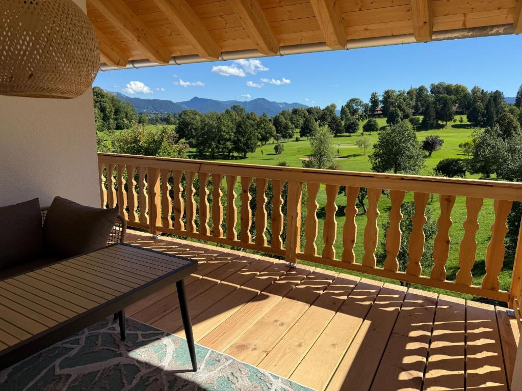 a balcony with a bench and a view at Schwaigerhof in Wackersberg