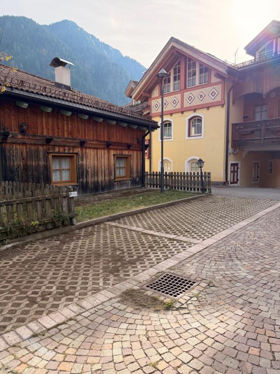 a cobblestone street in front of a building at Cèsa Emily in Campitello di Fassa