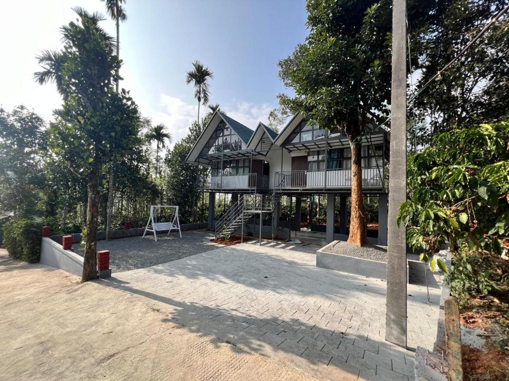 a house on the beach with trees in front of it at Nefs Dreams Villa in Vaduvanchal