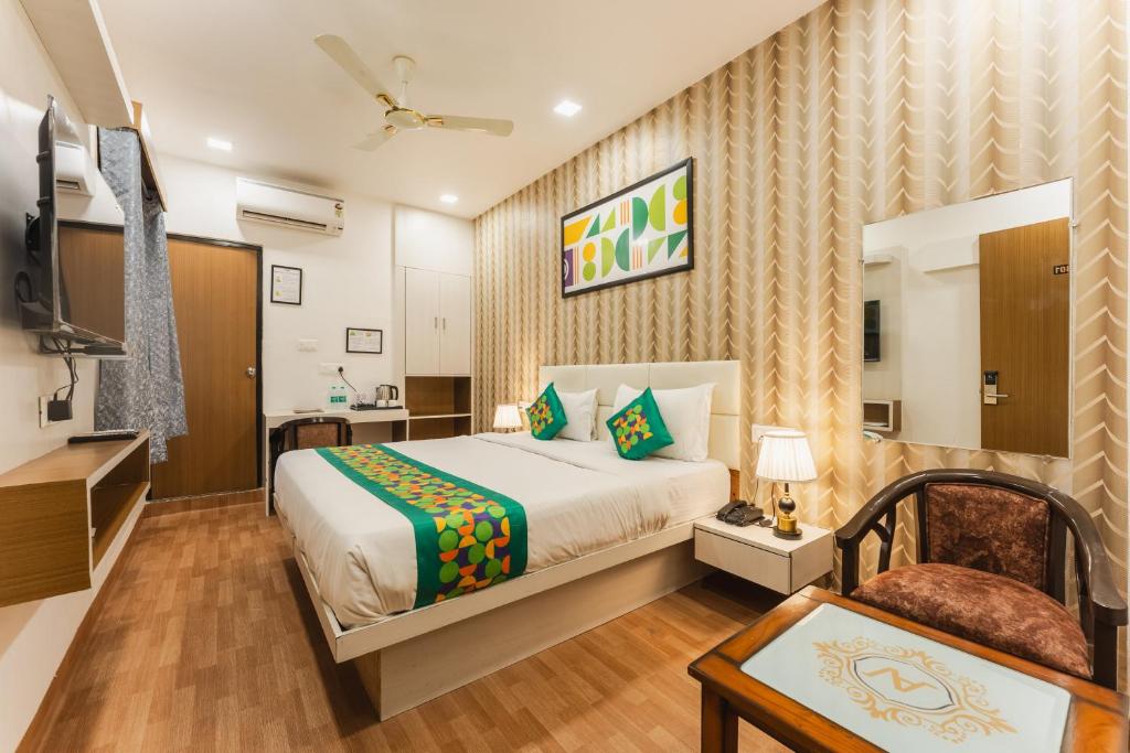 a bedroom with a bed and a television in a room at Treebo Advantage Inn in Allahābād