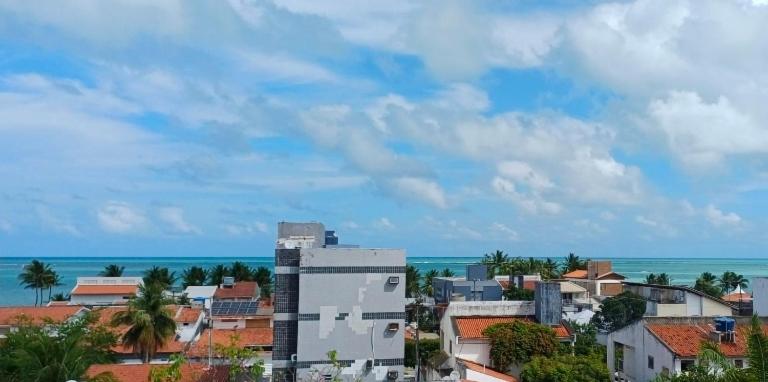 a view of a city with the ocean in the background at Apartamento Cobertura Praia Camboinha in Cabedelo