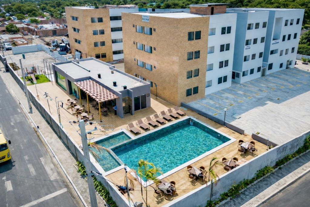 an overhead view of a swimming pool in front of a building at Cantinho do Sossego in João Pessoa