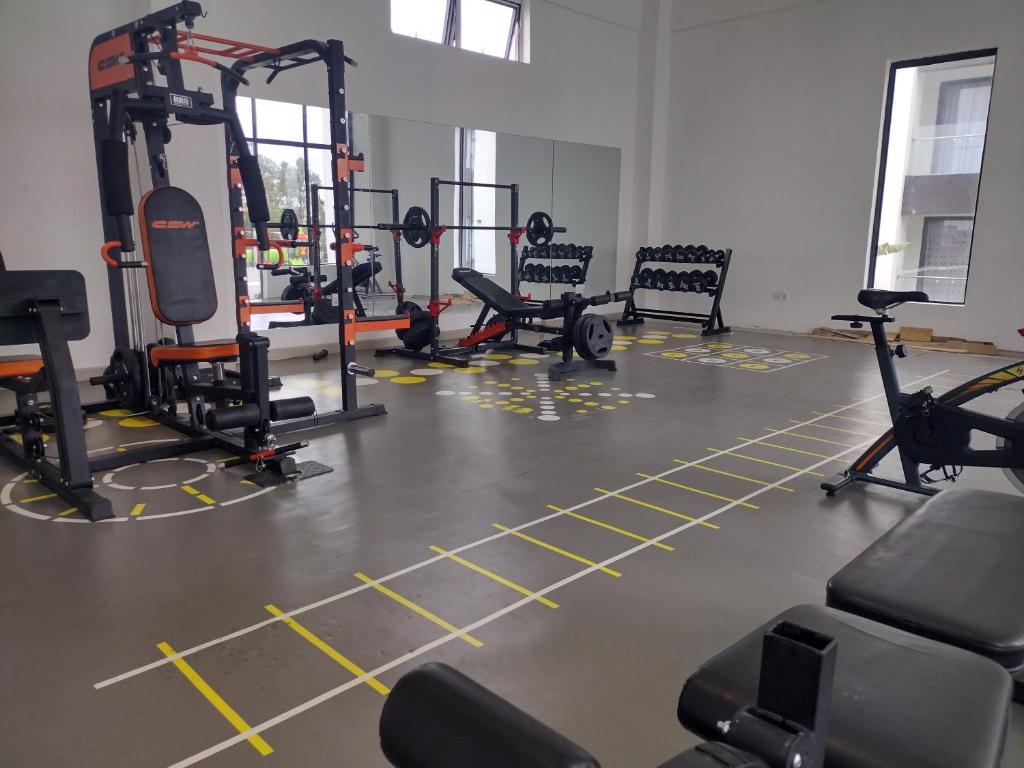 a gym with several tread machines on the floor at Serenity Apartment Artesano in Nairobi