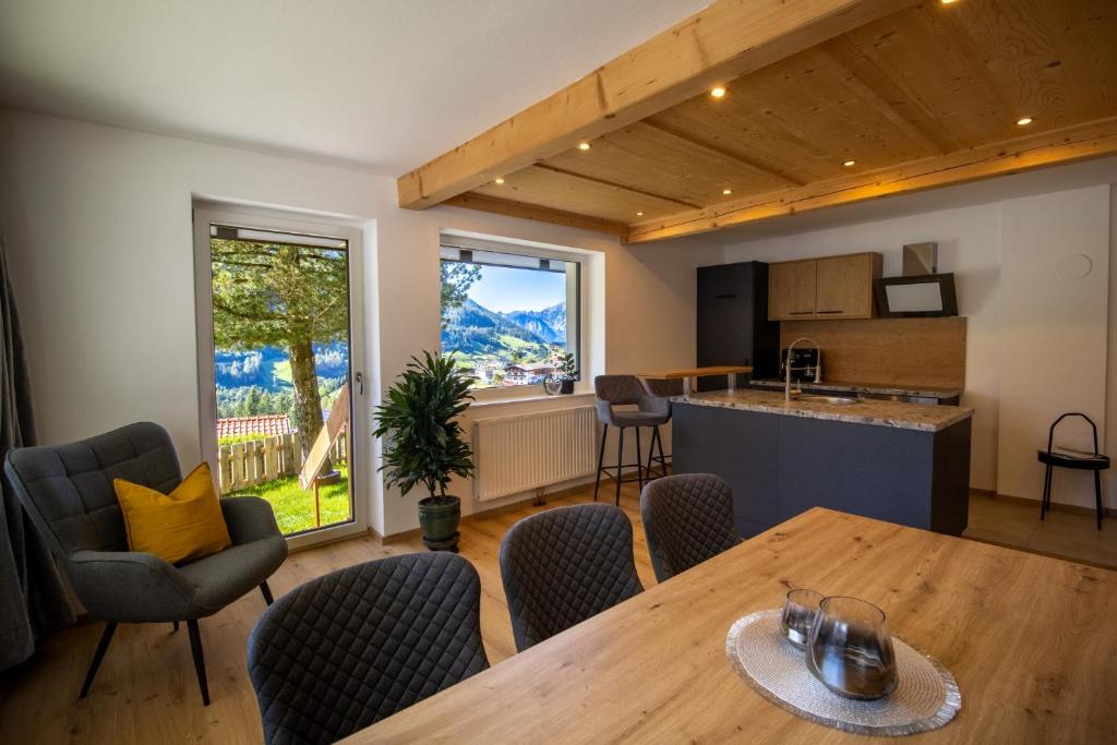 a kitchen and living room with a table and chairs at Apartement Waldfrieden in Pfons