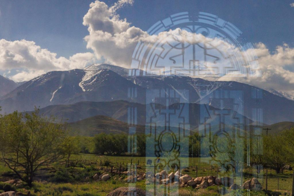 een schilderij van een berg met dieren in een veld bij Om infinity - Pre opening in Tupungato