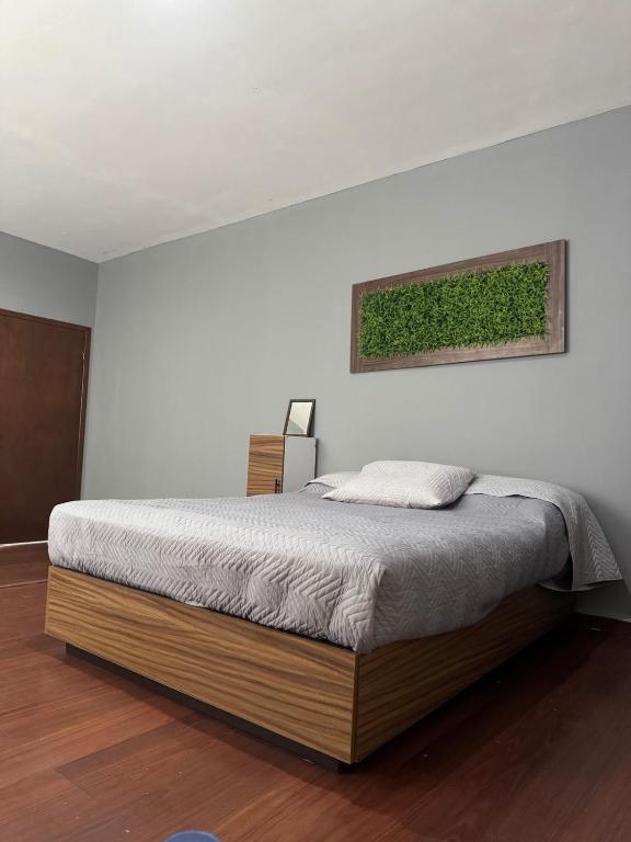 a bed in a white room with at Departamento Moderno y Centrico check in autonomo no necesitas llaves in Guaymas