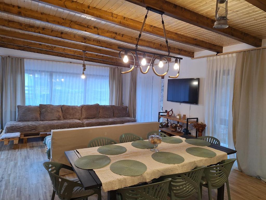 a dining room with a table and a couch at Casa Delia in Balta