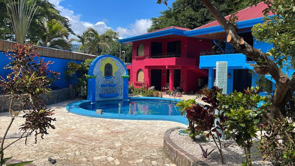 a house with a swimming pool in front of a house at Hotel Carmen Costa Coral in Tambor