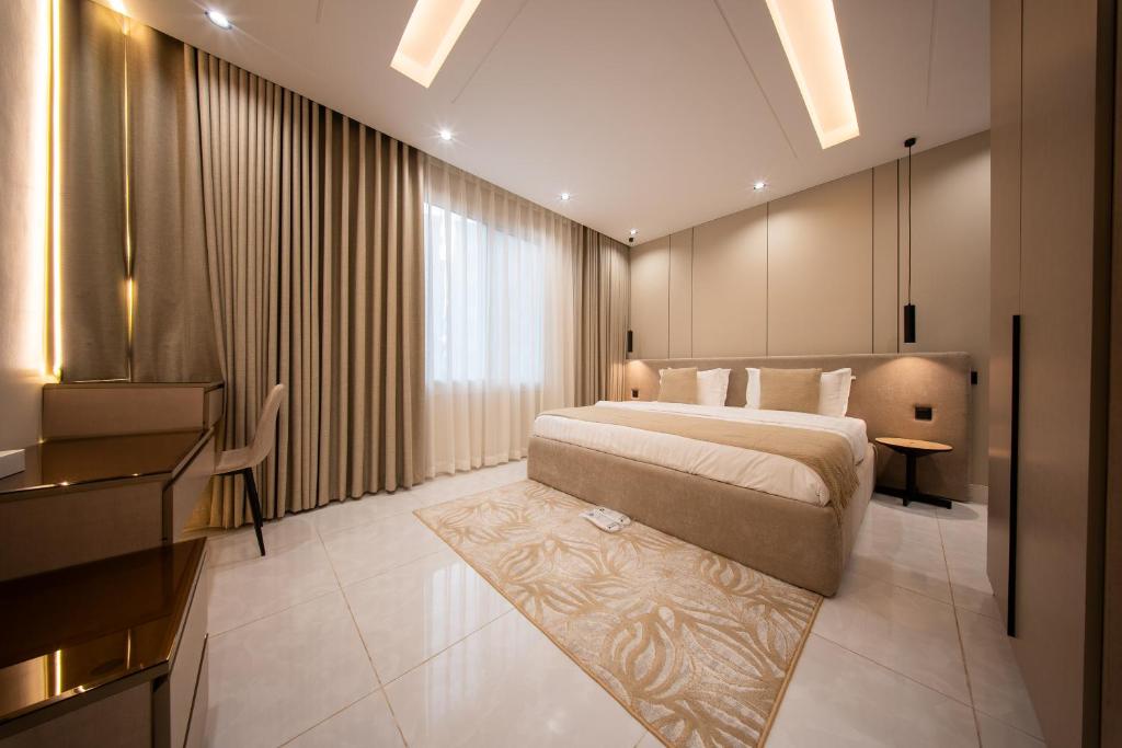 a hotel room with a bed and a desk at Revana for families in Jeddah