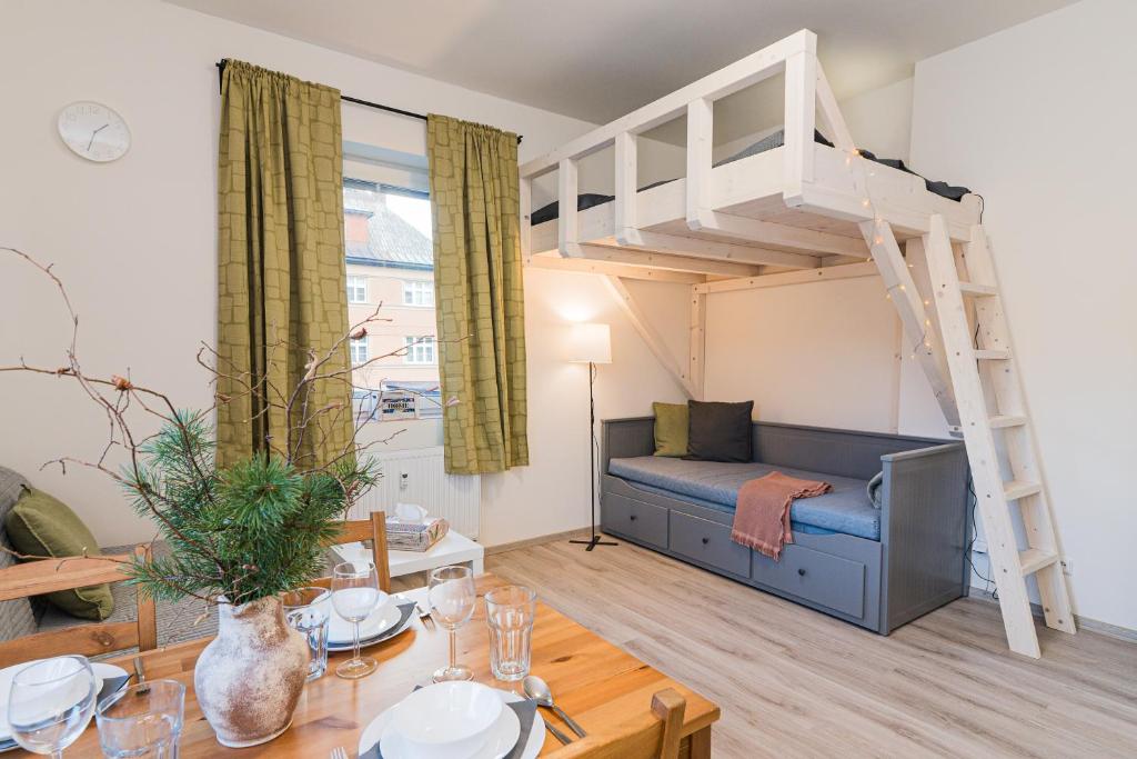 a living room with a loft bed and a dining table at Za radnicí 2 & 5 by Mountain ways in Rokytnice nad Jizerou