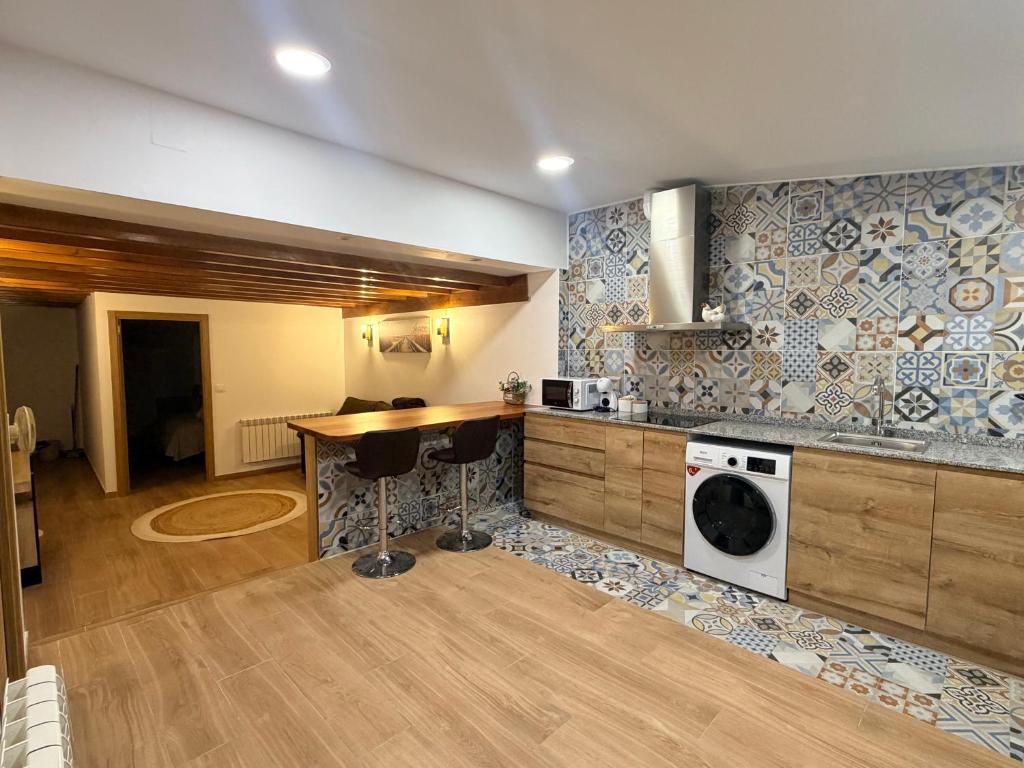 a kitchen with a counter and a sink and a stove at Suite La Madriguera - Hostal Merindades in Villarcayo