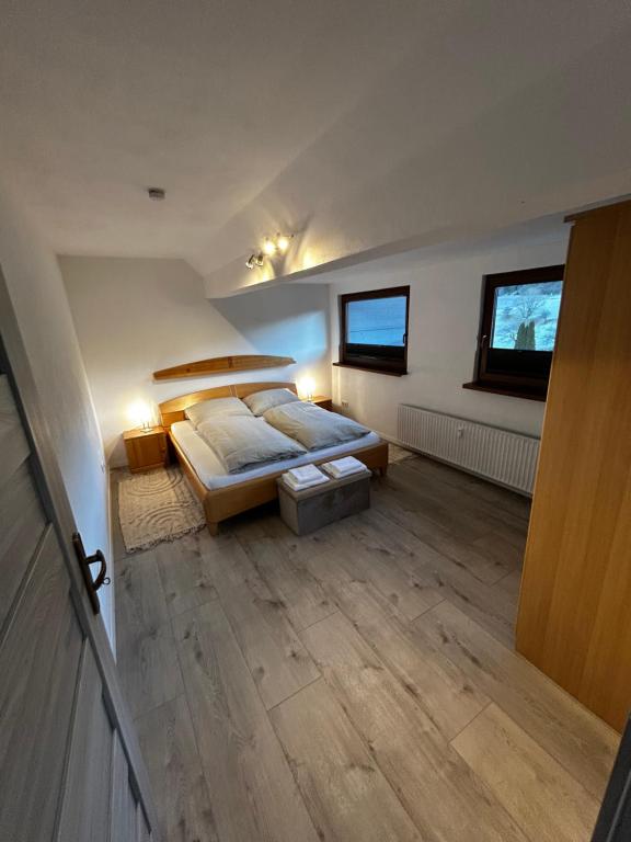a bedroom with a bed and a wooden floor at Zwei schöne Ferienwohnungen in der Nähe von Winterberg in Rengershausen