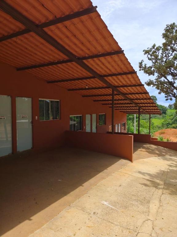 a large building with awning over a patio at Hotel Apis Silvestre in Cruzeiro da Fortaleza