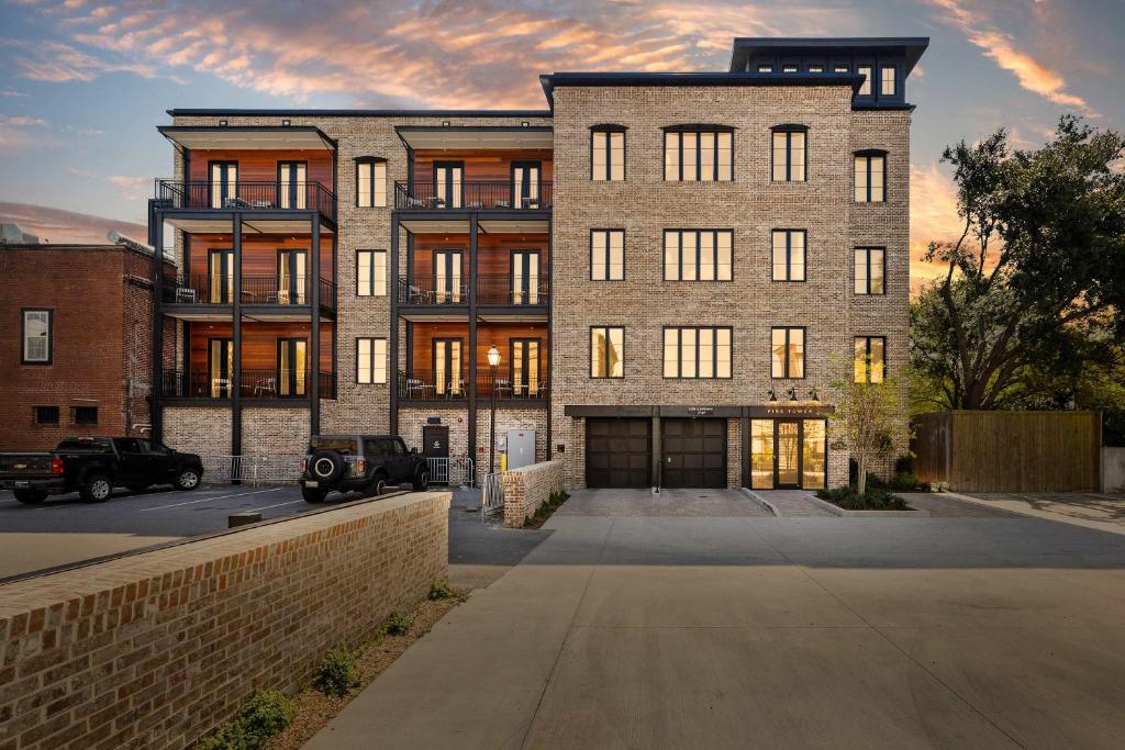 a large brick building with a driveway in front of it at Fire Tower Classy 1BR in Downtown Charleston in Charleston