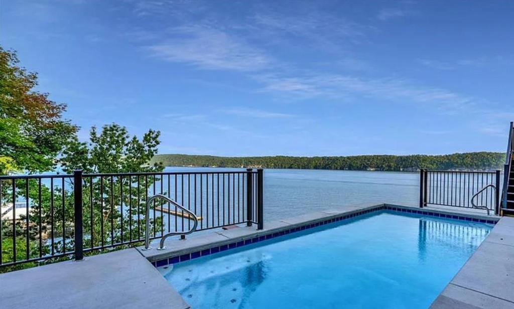 a swimming pool with a view of the water at The Royal Chateau-5BED6BATHPoolHottub-20PP in Osage Beach