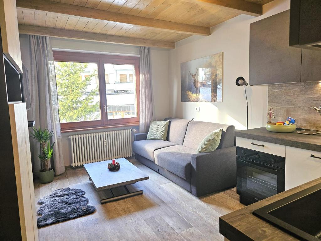 a living room with a couch and a table at Moda Apartments 47 in Sestriere