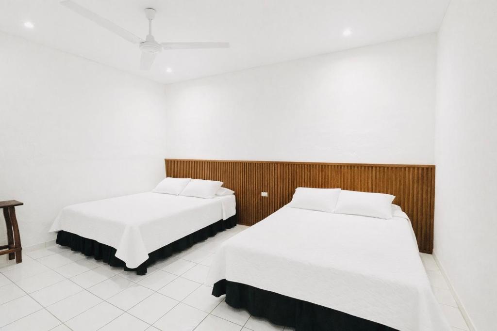 Postel nebo postele na pokoji v ubytování Hotel Raíces Ataco