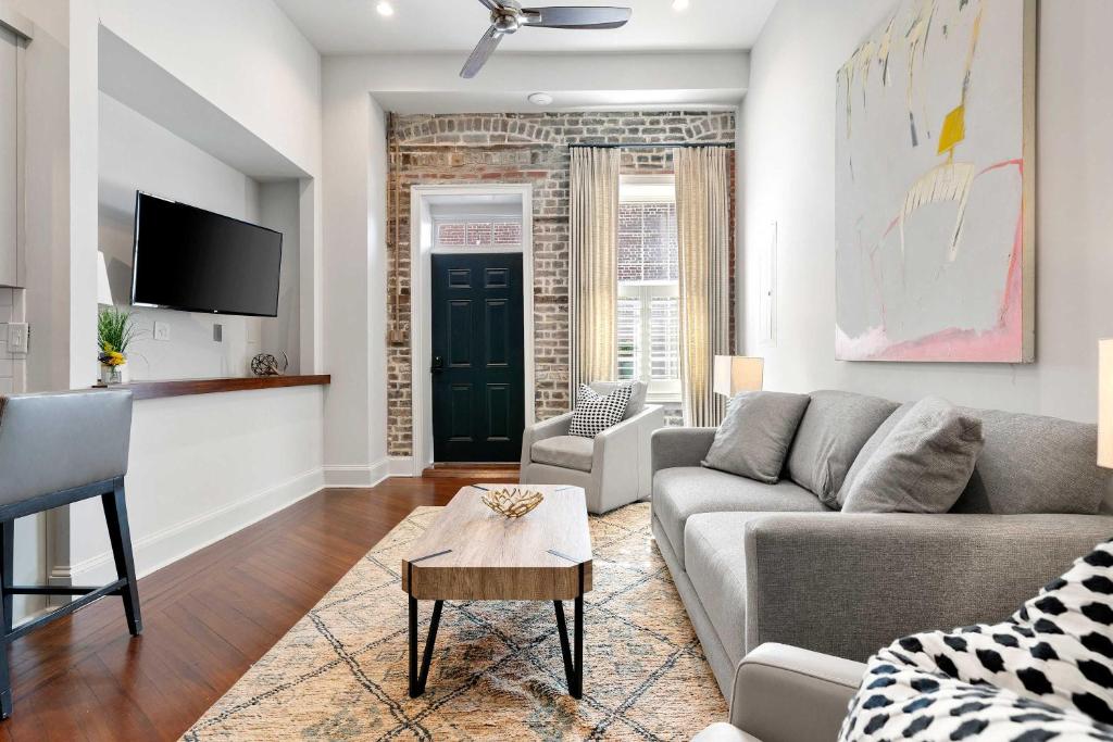 a living room with a couch and a tv at King Street Condo - Endless Outdoor Space in Charleston