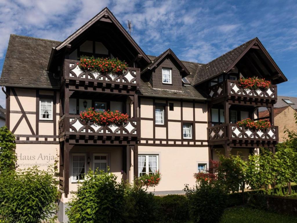 an old house with flower boxes on the windows at Apartment FEWO Veilchen by Interhome in Ernst