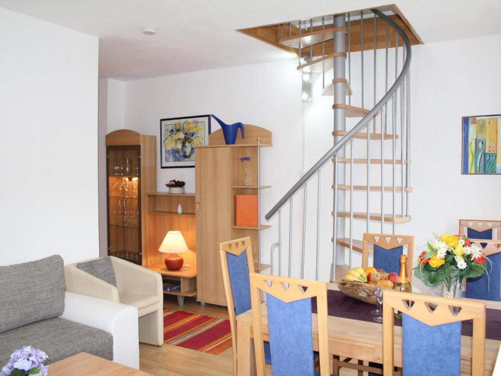 a living room with a table and a staircase at Apartment Daun by Interhome in Daun