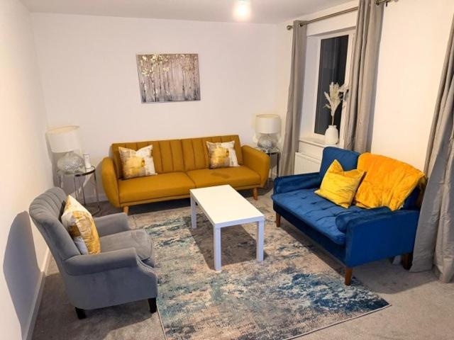 a living room with two couches and a table at Kennard Haven in Weldon