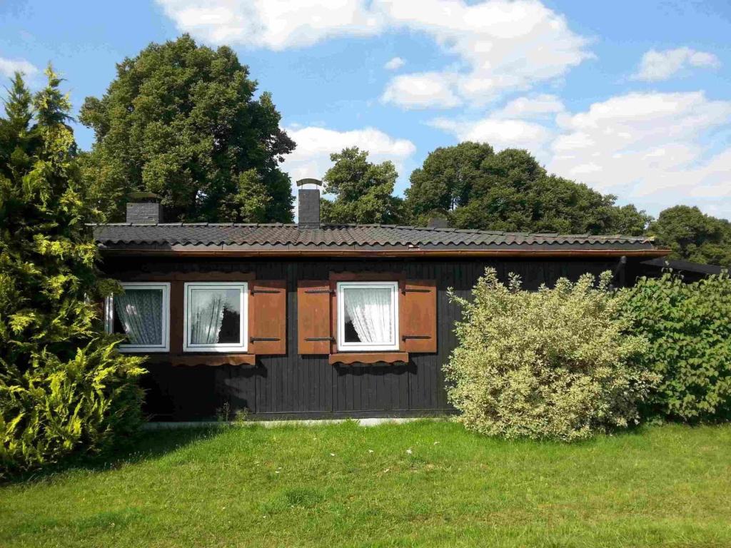 a small house in a field with trees in the background at Holiday Home Barbara by Interhome in Kittlitz
