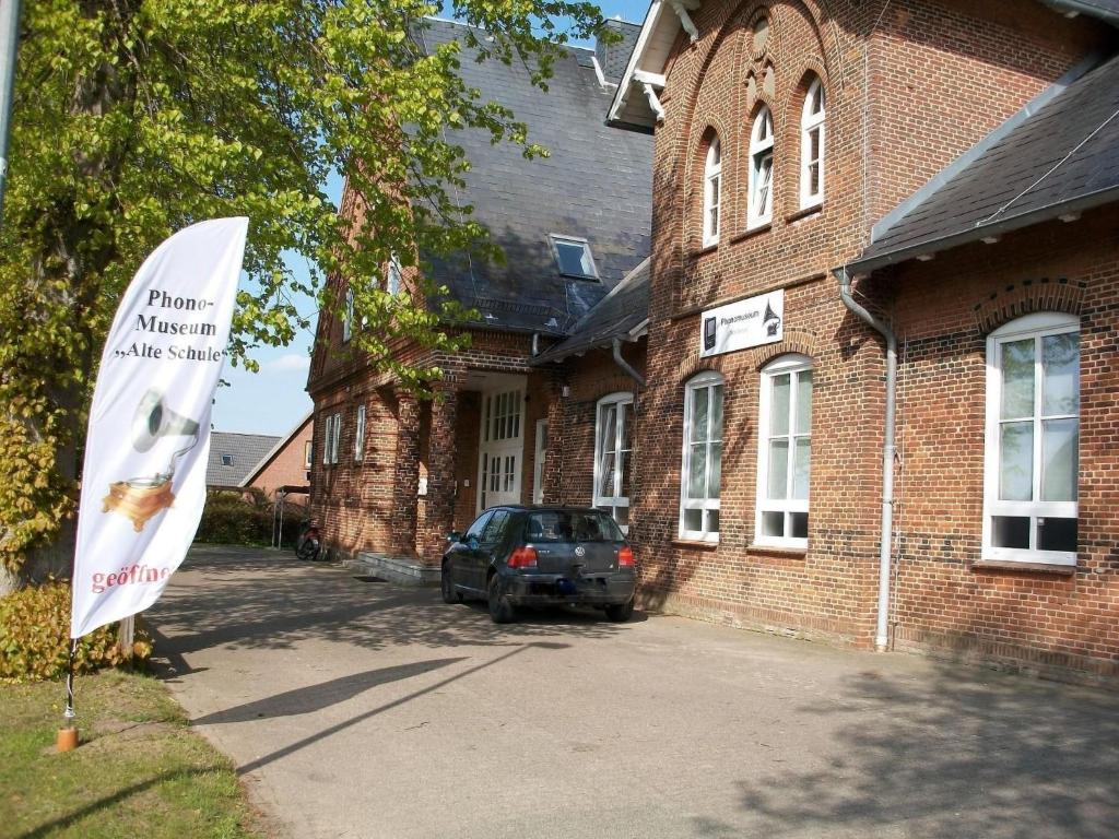 a sign in front of a brick building at Apartment Fewo Edison by Interhome in Holzdorf