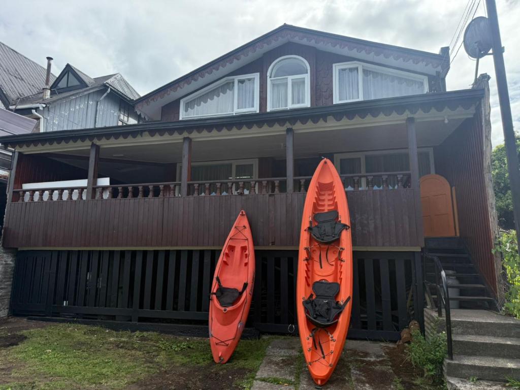 zwei Kajaks werden vor einem Haus geparkt in der Unterkunft Raíces de Gamboa in Castro