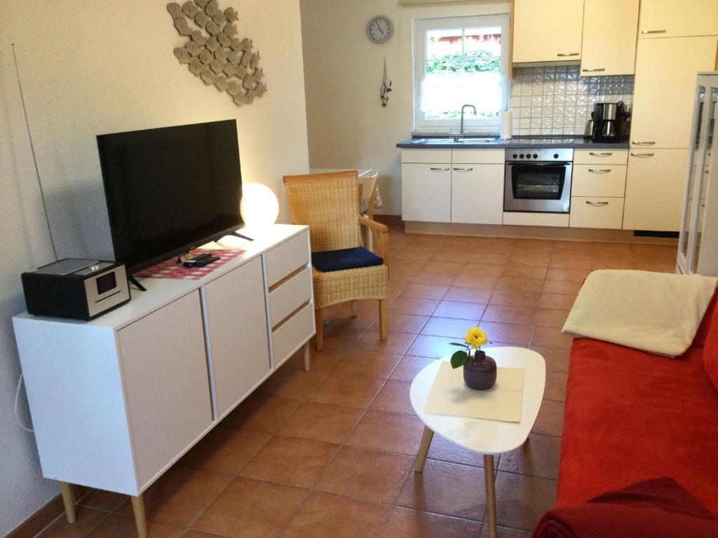 a living room with a flat screen tv on a cabinet at Apartment in Dassow by Interhome in Feldhusen