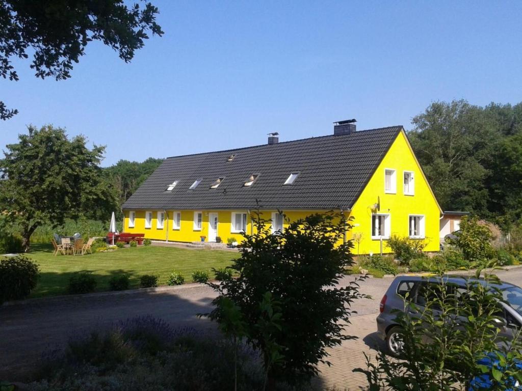 a yellow house with a black roof at Apartment 3 by Interhome in Feldhusen