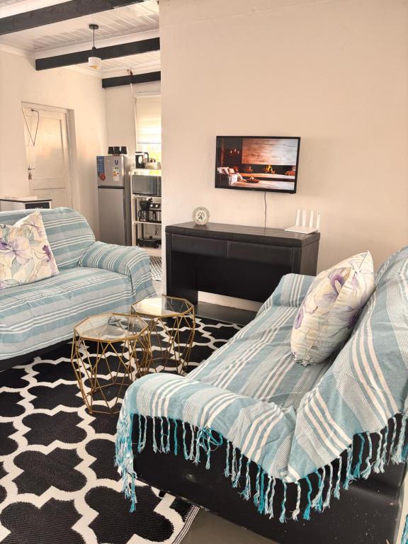 a living room with two couches and a tv at Cape Comfy Hidden Home in Cravenby